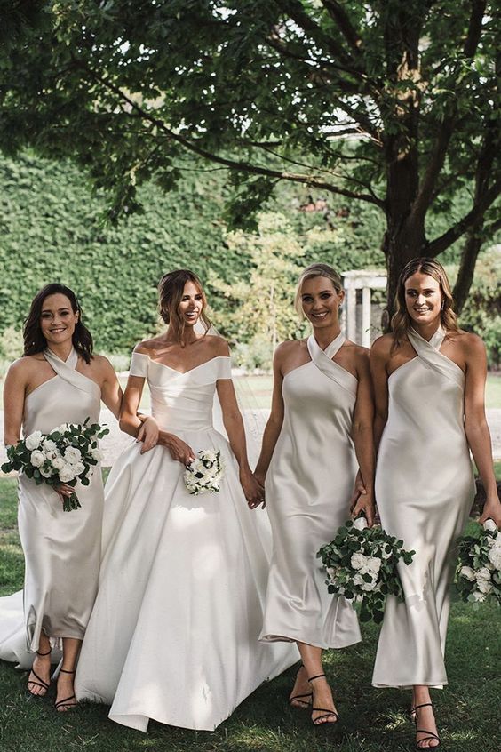 matching ivory halter neckline midi bridesmaid dresses with a hoop are a very elegant and modern idea to go for