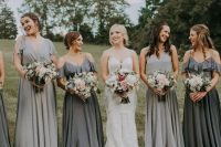 mismatching dove and graphite grey maxi bridesmaid dresses with a cold shoulder and thick straps and V necklines