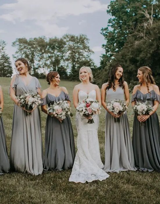 mismatching dove and graphite grey maxi bridesmaid dresses with a cold shoulder and thick straps and V necklines