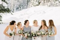 mismatching dove grey and silver grey bridesmaid gowns for an elegant and chic look at a winter wedding