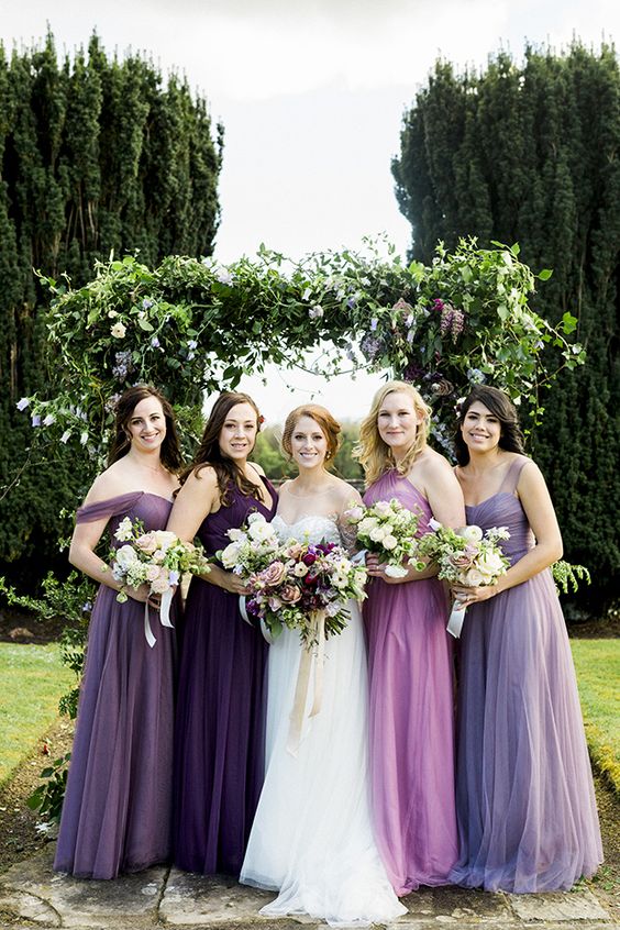 mismatching lilac, violet and mauve maxi bridesmaid dresses with various necklines are amazing for a wedding with this color palette
