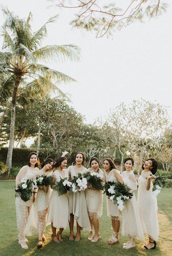 mismatching neutral midi bridesmaid dresses with polka dots and various sandals for a modern tropical wedding