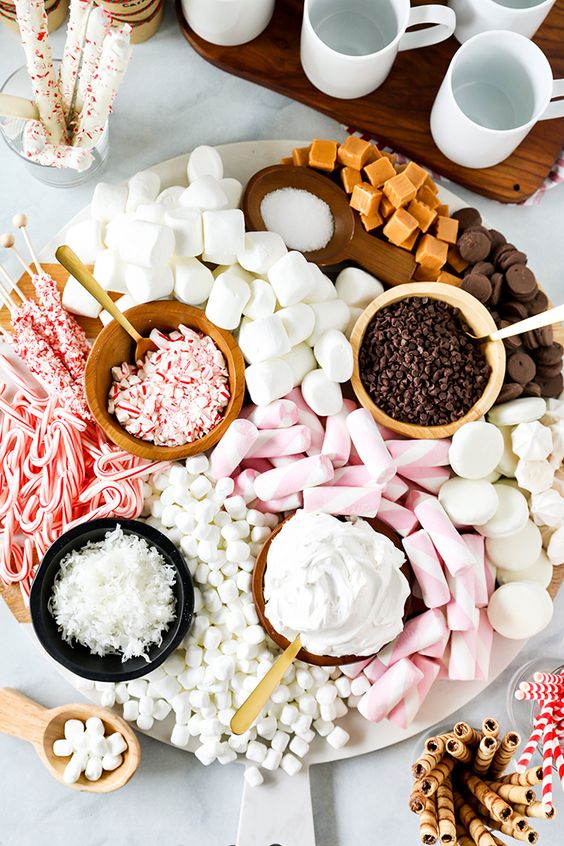 offer a hot chocolate dessert board withmarshmallows, chocolate, caramel, coconut and some peppermints