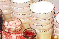 paper cups with srpinkles and candies and sweets in jars are a cool idea for styling your hot cocoa bar
