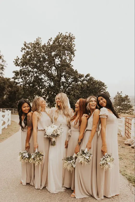 pretty mismatching relaxed maxi bridesmaid dresses in various grey tones are a gorgeous idea for a boho wedding