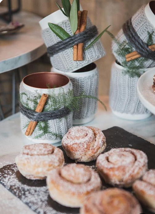 serve cinnamon buns and hot chocolate in copper mugs wrapped in knit, twine and cinnamon bark