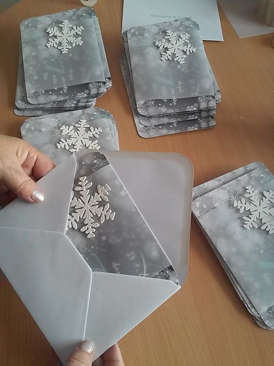 silver grey winter wedding invites with snowflakes and in grey envelopes for a trendy look