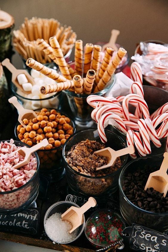 sweets, nuts and candies plus toppings served in the same glass bowls are a stylsih idea for a hot chocolate bar