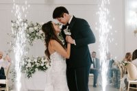 the couple’s first dance as a married couple lit up by sparklers is a lovely idea for a modern wedding with a touch of glam