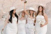 white slip midi bridesmaid dresses, silver heels and hats are amazing for a boho spring or summer bridal party