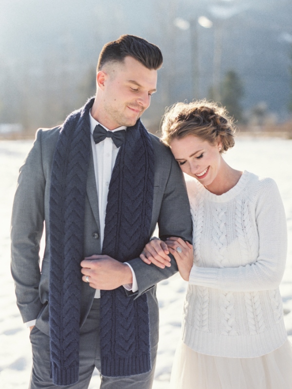 a white cable knit bridal sweater and a navy cable knit scarf to tie up your couple look