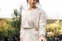 a gorgeous slouchy neutral cable knit sweater is a nice coverup idea for a boho bride, highlight your waist with a belt