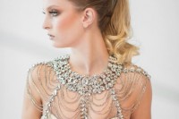 a heavily embellished shoulder jewelry piece with larger and smaller gems is a refined and chic item to accent your glam look