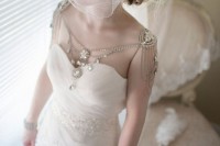 a vintage bridal look with a strapless wedding dress and rhinestone shoulder jewelry plus a low hanging neckline with plenty of rhinestones