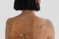 elegant gold and rhinestone jewelry on the shoulders and on the back to accent an open back