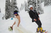 the couple riding snowboards is a cool idea for a wedidng portrait, fun and bold
