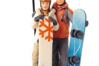 a creative wedding cake topper showing off the couple with their snowboards