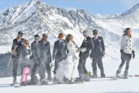 a happy couple and their guests on top the mountain for wedding portraits