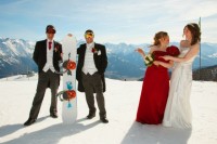 a groom and groomsman wearign morning suits and holding a snowboard and a bride and her bridesmaid next to them