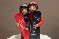 bright wedding cake toppers with colorful snowboards and Just Married on them