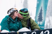 a happy couple with their snowboards and wedding date are a nice idea for wedding portraits