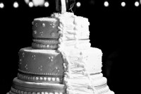 a white textural wedding cake with snowboard toppers is a fun and whimsy idea for a snowboard-loving couple