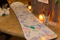 a snowboard instead of a usual wedding guest book is a creative and natural idea for a snowboard wedding