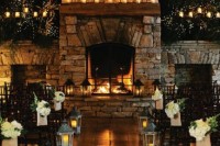 candles, a candle chandelier, candles lanterns and lights make this cozy rustic space very welcoming