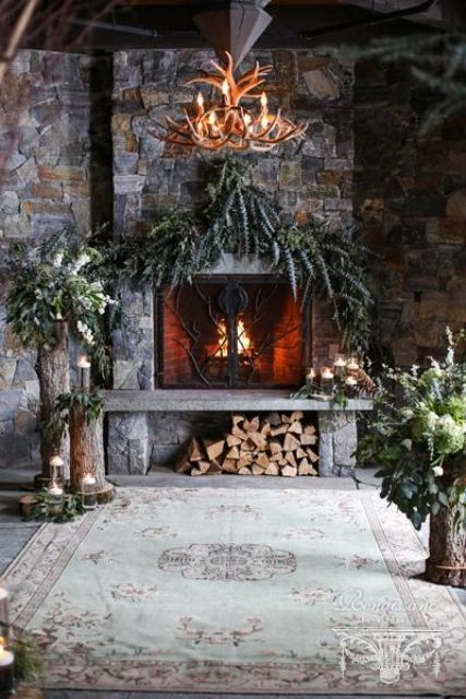 lush greenery, candles in glasses, firewood and greenery and bloom arrangements on tree stumps