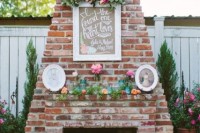 a working fireplace with frames, bright blooms and greenery for a chic and bright look in your wedding lounge