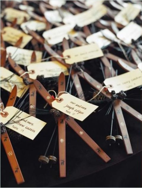 skis and ski poles plus tags as seating cards double as wedding favors at a ski resort wedding