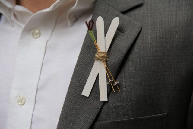 a simple ski and ski pole boutonniere to spruce up the look of the groom