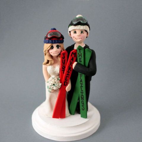 funny and cute ski wedding cake toppers with colorful skis are ideal for a modern ski resort wedding