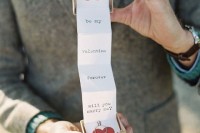 a groom popping up the question in a creative way – with a box with letters and hearts is a lovely vintage-inspired idea