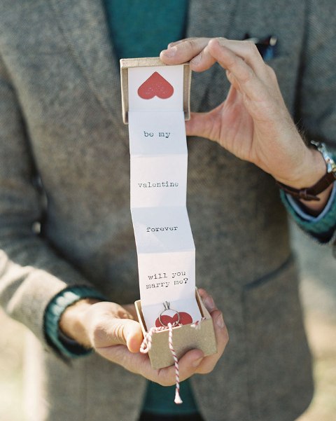a groom popping up the question in a creative way - with a box with letters and hearts is a lovely vintage-inspired idea