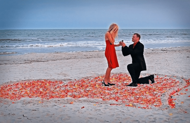 a romantic Valentine engagement on the beach in a heart made of petals is a cool and timeless idea for a Valentine's Day