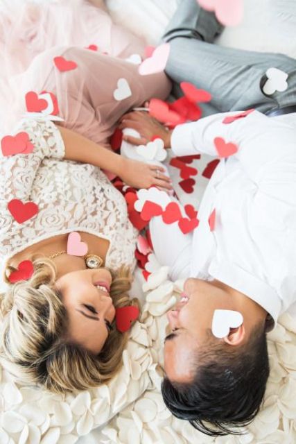 a pretty and easy Valentine's Day engagement pic with lots of paper hearts is a perfect idea of a photo that is easy to realize