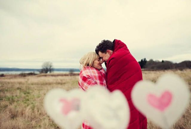 cozy up in pretty red and pink blankets, add some hearts, and a cool Valentine engagement photo is ready