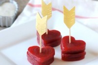 heart-shaped beet stacks topped with gold arrows are lovely Valentine wedding appetizers to enjoy
