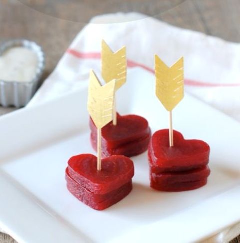heart-shaped beet stacks topped with gold arrows are lovely Valentine wedding appetizers to enjoy