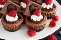 chocolate fudge cupcakes with frosting, chocolate pieces and raspberries are lovely sweet appetizers or desserts for a Valentine’s Day wedding
