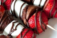 sweet Valentine wedding appetizers – skewers with marshmallows, chocolate cake and strawberries and chocolate glazing