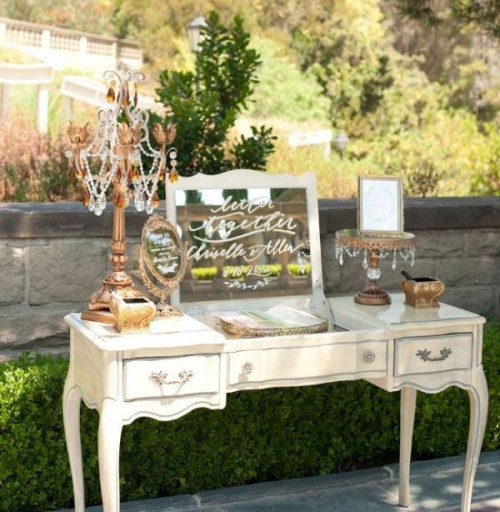 a white vintage dresser with mirrors that are signs, a candelabra, crystals and boxes is a lovely idea for a vintage wedding