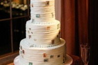 a textural white wedding cake decorated with edible stamps hints on travelling
