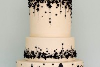 an elegant neutral and black wedding cake with a tier featuring the views of London