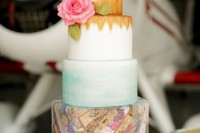 a bold wedding cake with a mint ombre touch, some gold and colorful world map tier plus a fresh bloom