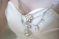 a very delicate with rhinestone epaulettes and a chic necklace with large embellishments is a romantic piece