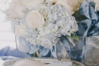 a delicate wedding centerpiece of white and serenity blue blooms is a lovely idea for a pastel spring or summer wedding