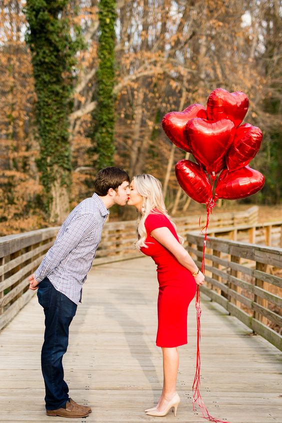 a Valentine's Day engagement with a bunch of red heart balloons is a fun and cool idea for now