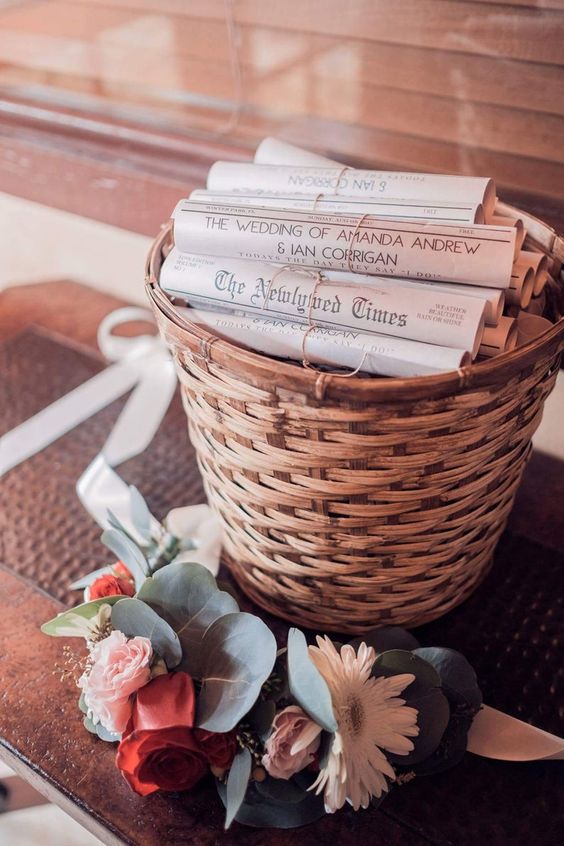a basket with newspaper dedicated to the couple and the wedding is a lovely and fun wedding favor idea to rock